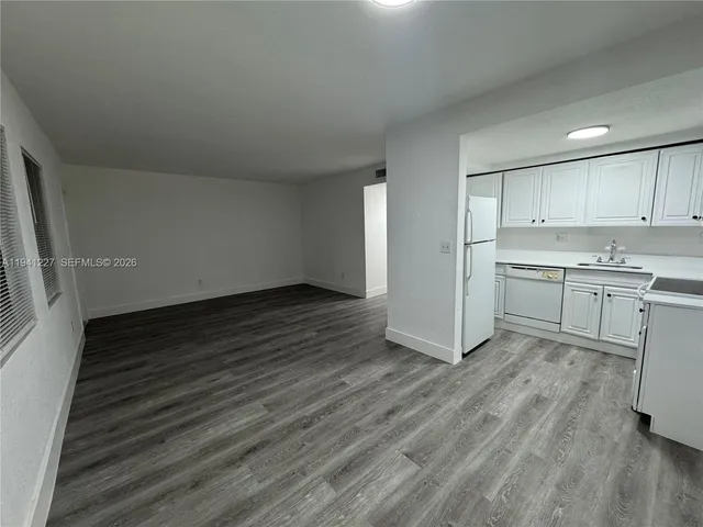a view of a kitchen with wooden floor