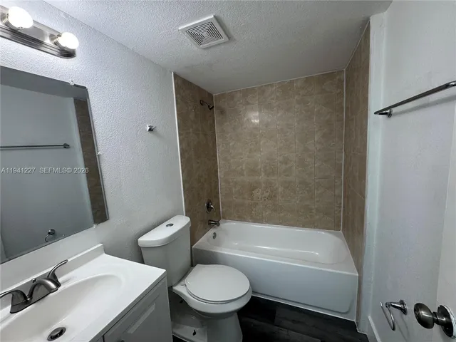 a bathroom with a sink mirror bathtub and toilet