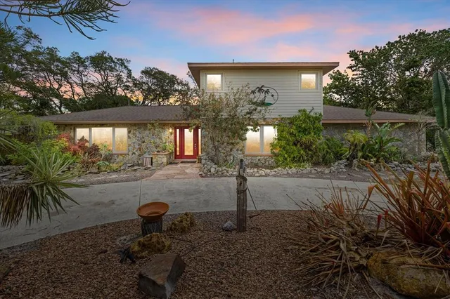 a view of yellow house with a yard