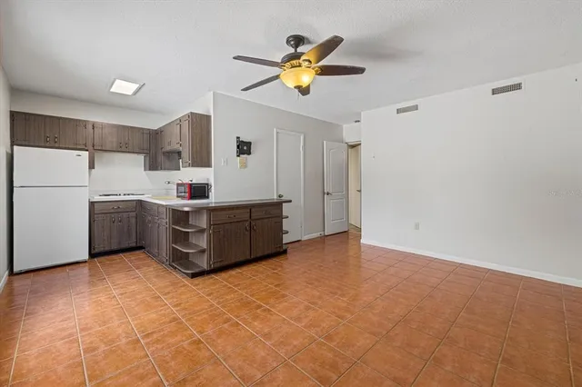 a living room with a ceiling fan furniture and a window