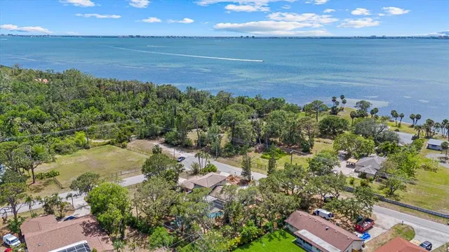 an aerial view of a house with outdoor space and a lake view