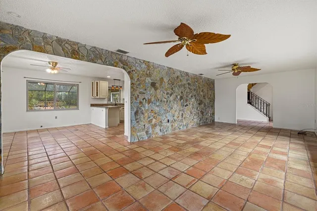a view of a livingroom with wooden floor and a ceiling fan