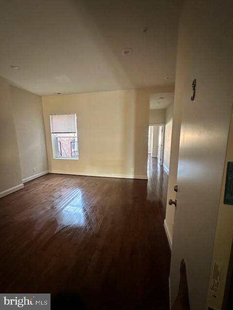 2740 St Paul Street, Unit 3 Baltimore, MD 21218 - Photo 2 of 6 a view of an empty room with wooden floor and a fan