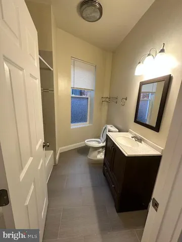 a bathroom with a sink a toilet and mirror