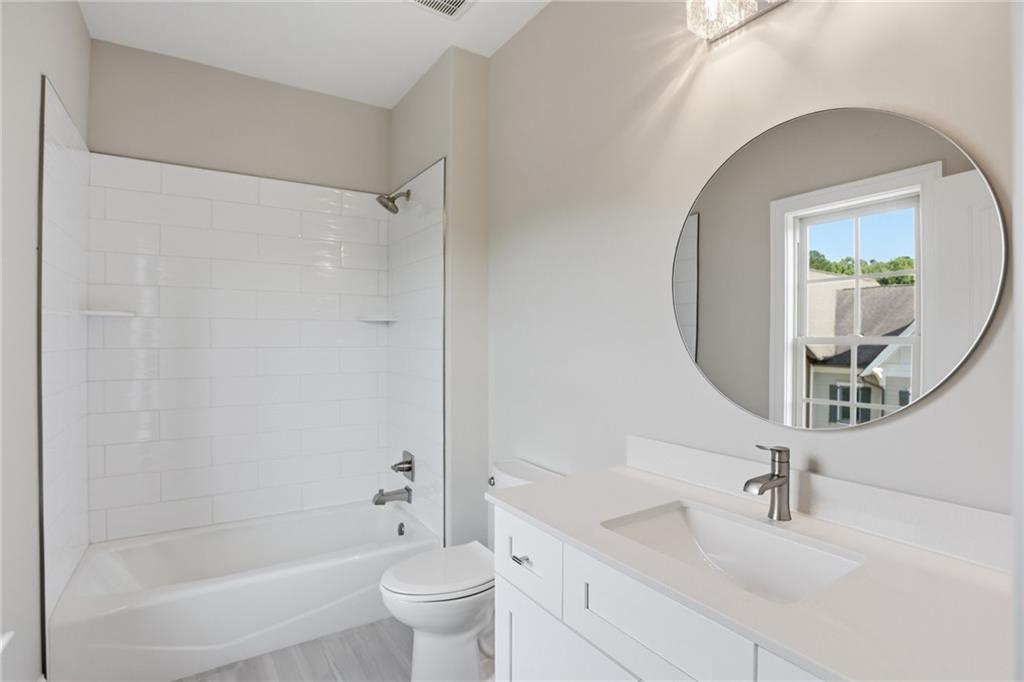 222 Trecastle Square, Unit 21 Canton, GA 30114 - Photo 25 of 33 a bathroom with a bathtub shower sink vanity and toilet