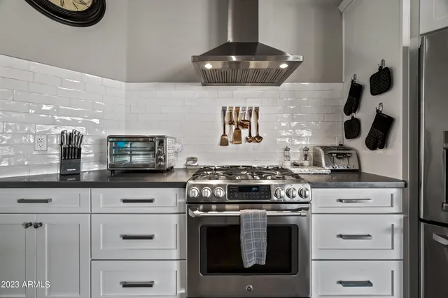 a kitchen with stainless steel appliances granite countertop a stove and a sink