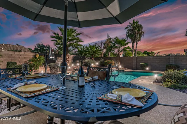 a view of a backyard with plants and patio