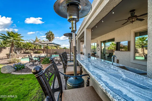 a view of a balcony with chairs and potted plants