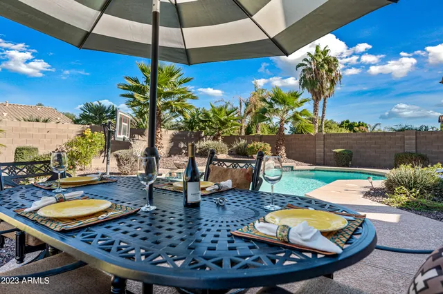 swimming pool view with a seating space