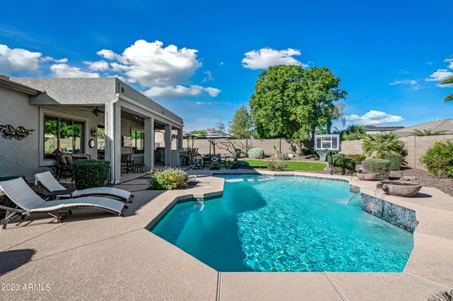 a view of swimming pool with outdoor seating and a patio