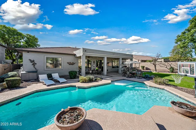a view of a house with backyard and sitting area