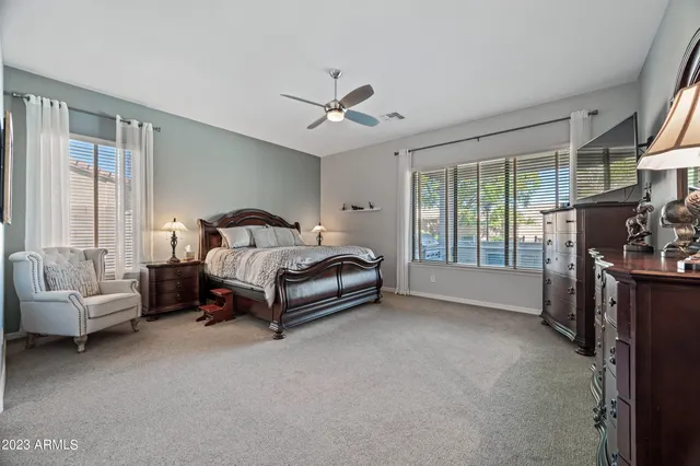 a spacious bedroom with a bed and a couch