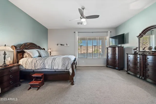 a bedroom with a bed dresser and a window
