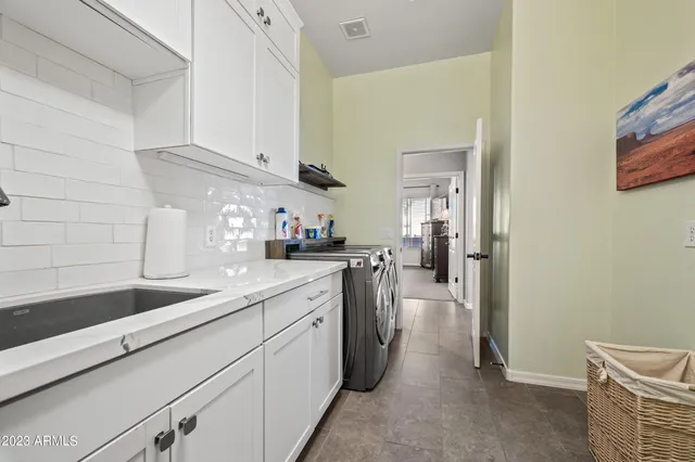 a kitchen with a sink and cabinets