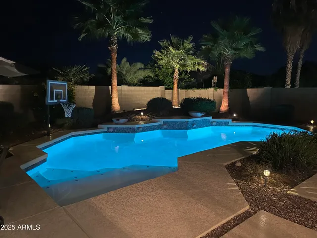 a view of a swimming pool with a yard