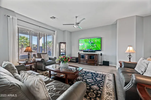 a living room with furniture fireplace and a large window