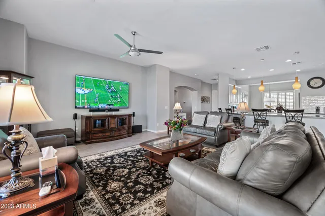 a living room with furniture flat screen tv and a fireplace