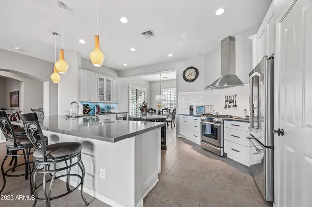a kitchen with cabinets and chairs