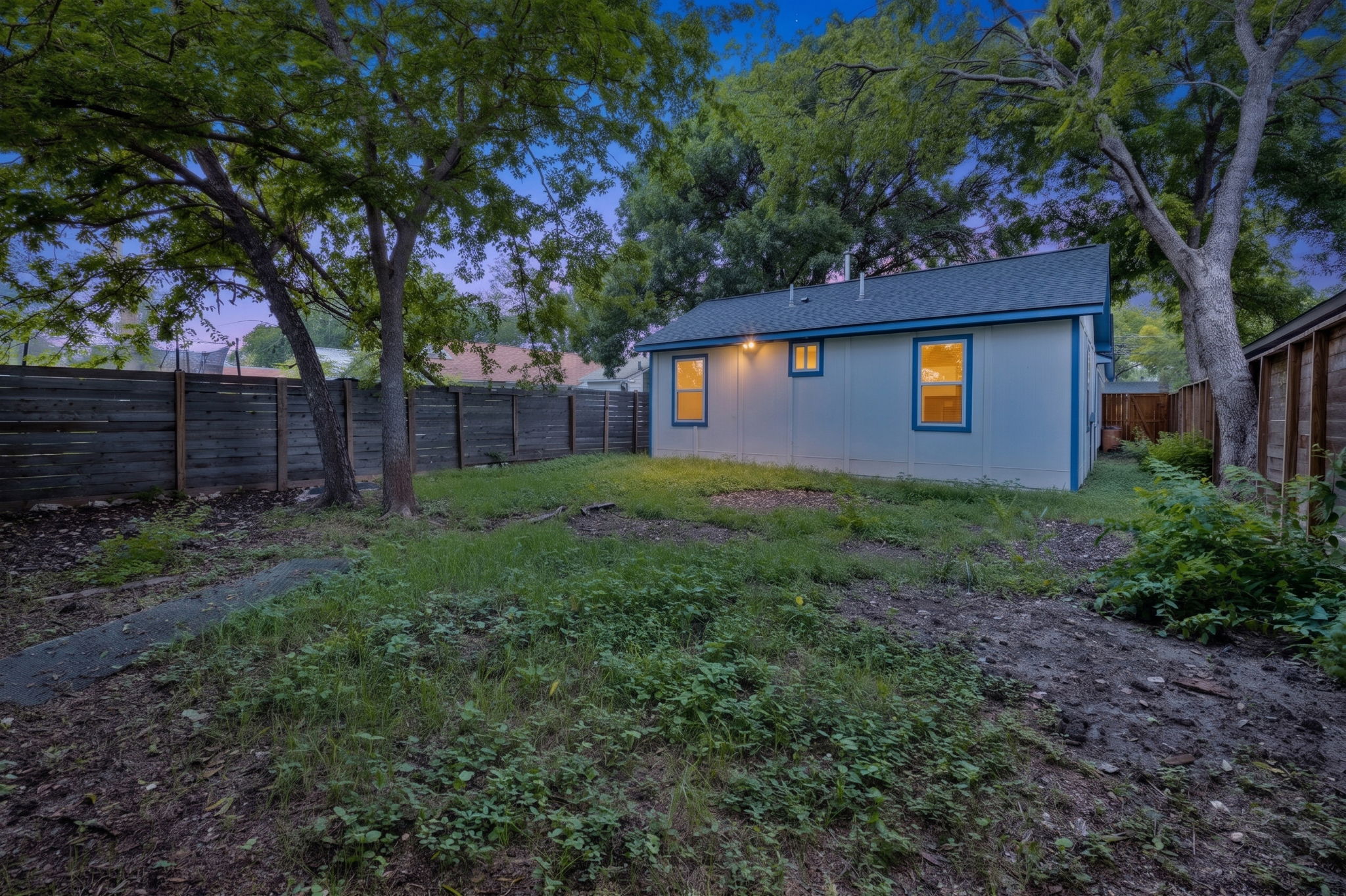 907 East 53rd Street Austin, TX 78751 - Photo 36 of 36 A private, fenced backyard offers a serene retreat with ample green space.