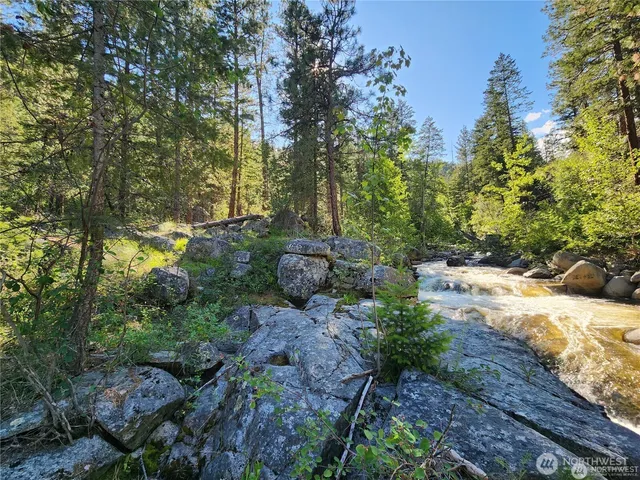 a backyard of a house with a yard and outdoor seating