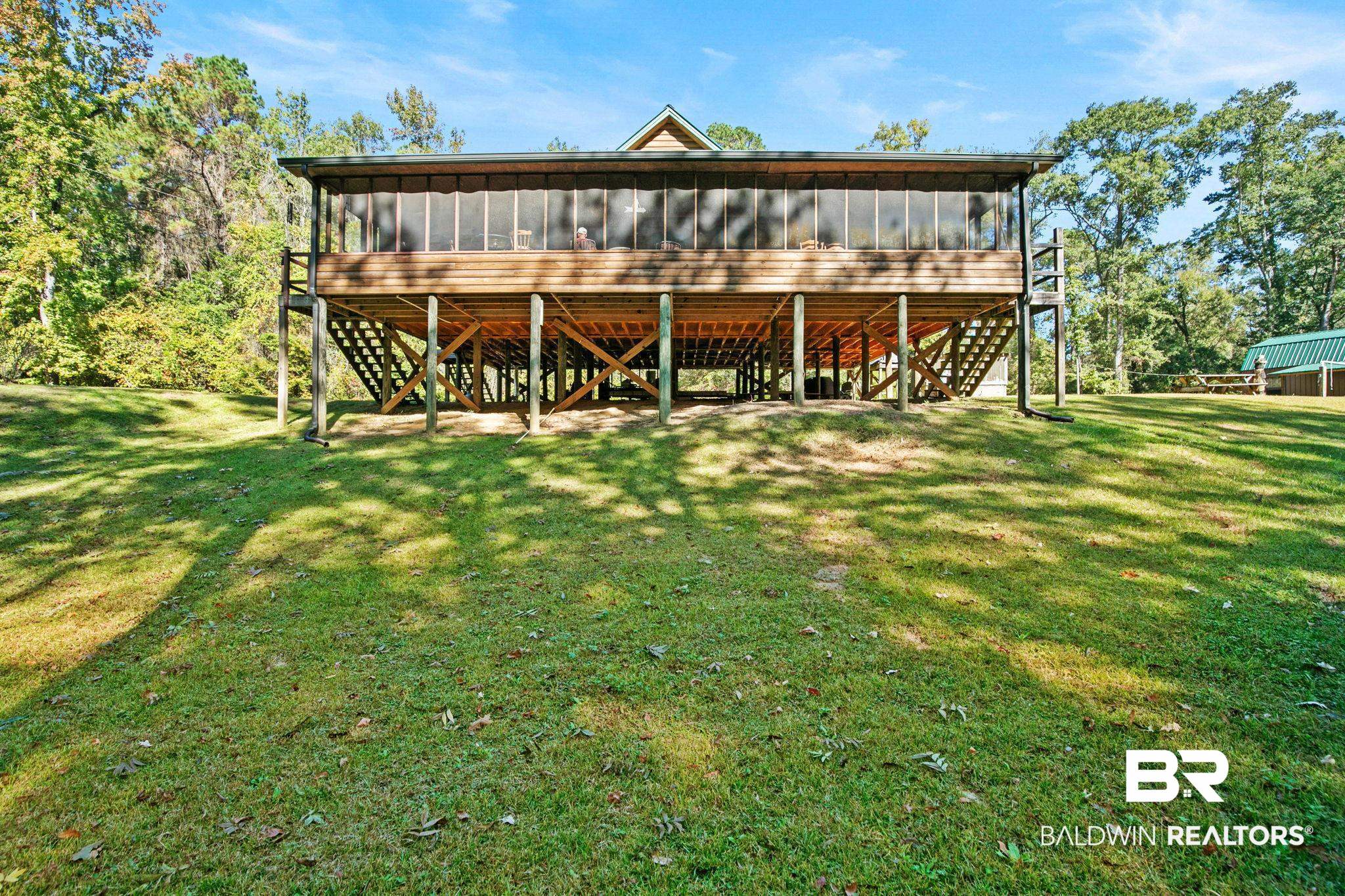 724 Rowell Lane Brewton, AL 36426 - Photo 3 of 40 Rear view of house featuring a sunroom, a deck, and a yard