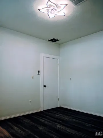 a bedroom with a bed rug and wooden floor