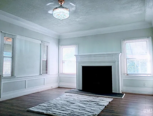 a living room with a fireplace and wooden floor