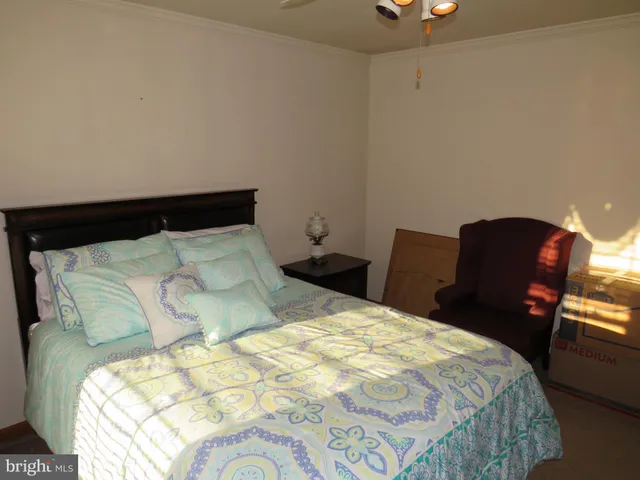 a bedroom with a bed and a lamp