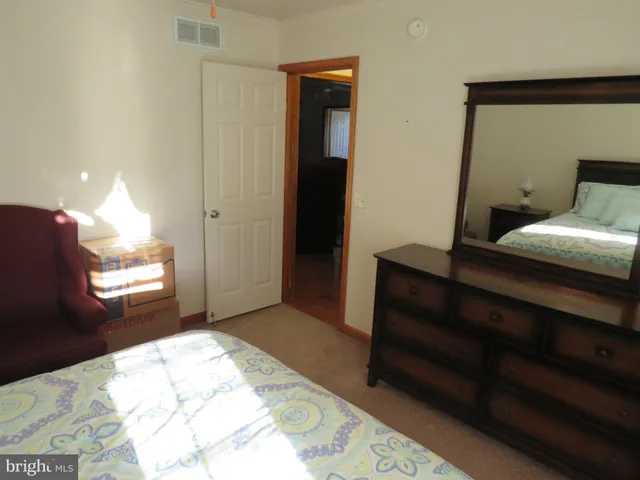 a bedroom with a bed and a dresser