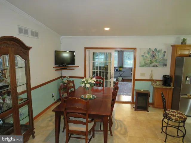 a view of a dining room with furniture and a flat screen tv