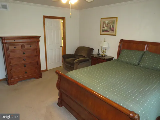 a bedroom with two beds and cabinet