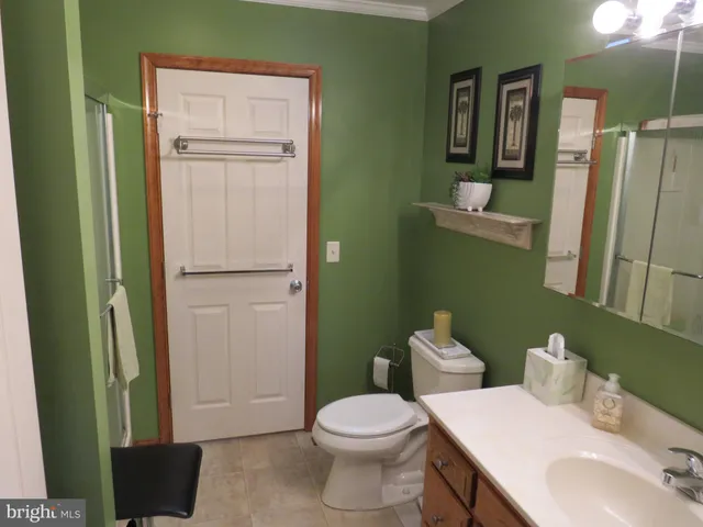 a bathroom with a toilet a sink and shower