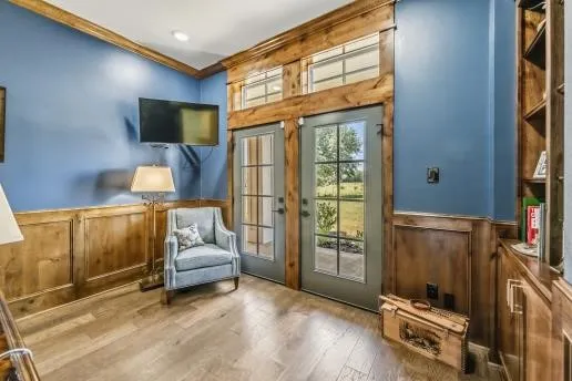 a kitchen with a stove and a wooden floor