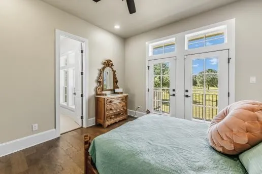 a view of a house with a yard and a large tree