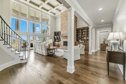 a living room with fireplace furniture and a wooden floor