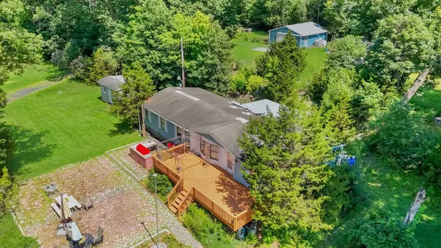 an aerial view of a house with yard swimming pool and outdoor seating