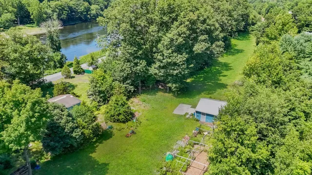 an aerial view of a house with a yard