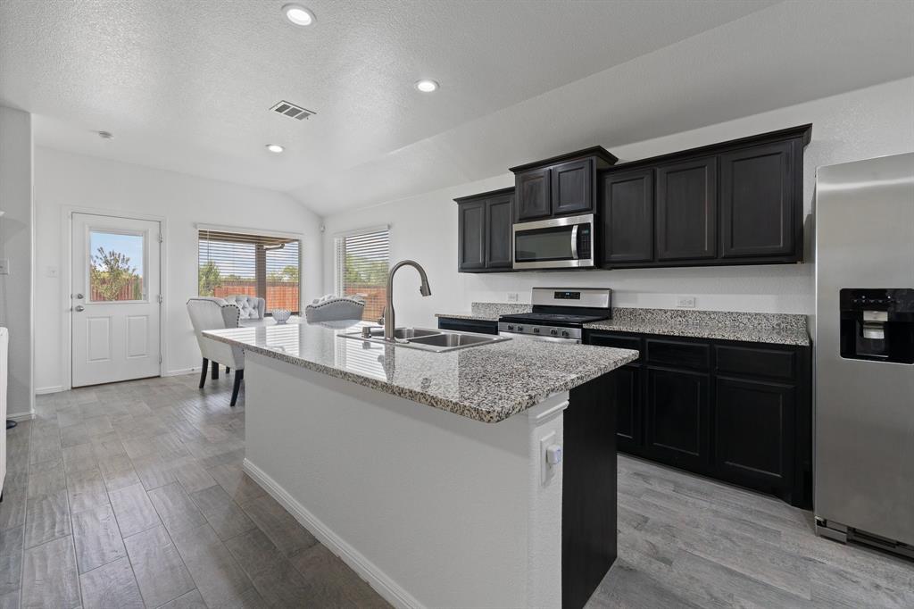 4600 Fringetree Way Crowley, TX 76036 - Photo 11 of 40 Kitchen featuring a central island with a double basin sink and a gooseneck faucet