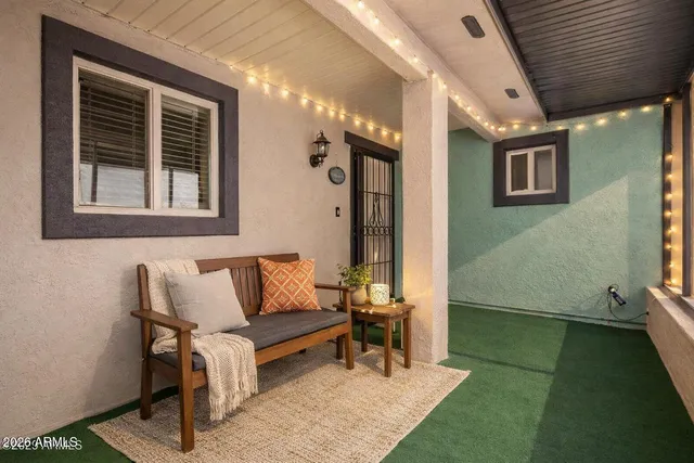 a outdoor living space with furniture and a rug