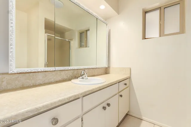 a bathroom with a sink and a mirror