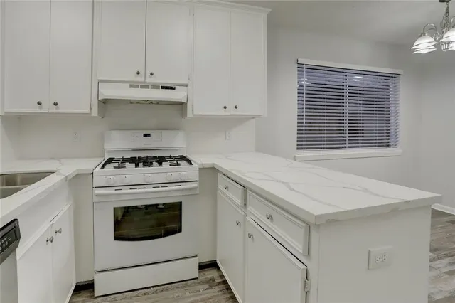 a kitchen with cabinets appliances and a sink