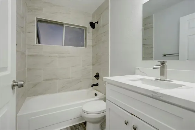 a bathroom with a sink a toilet and a bathtub