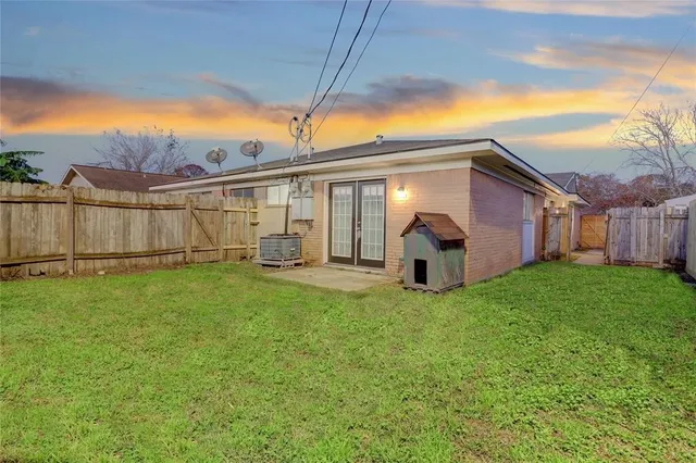 a view of a backyard with plants and a patio