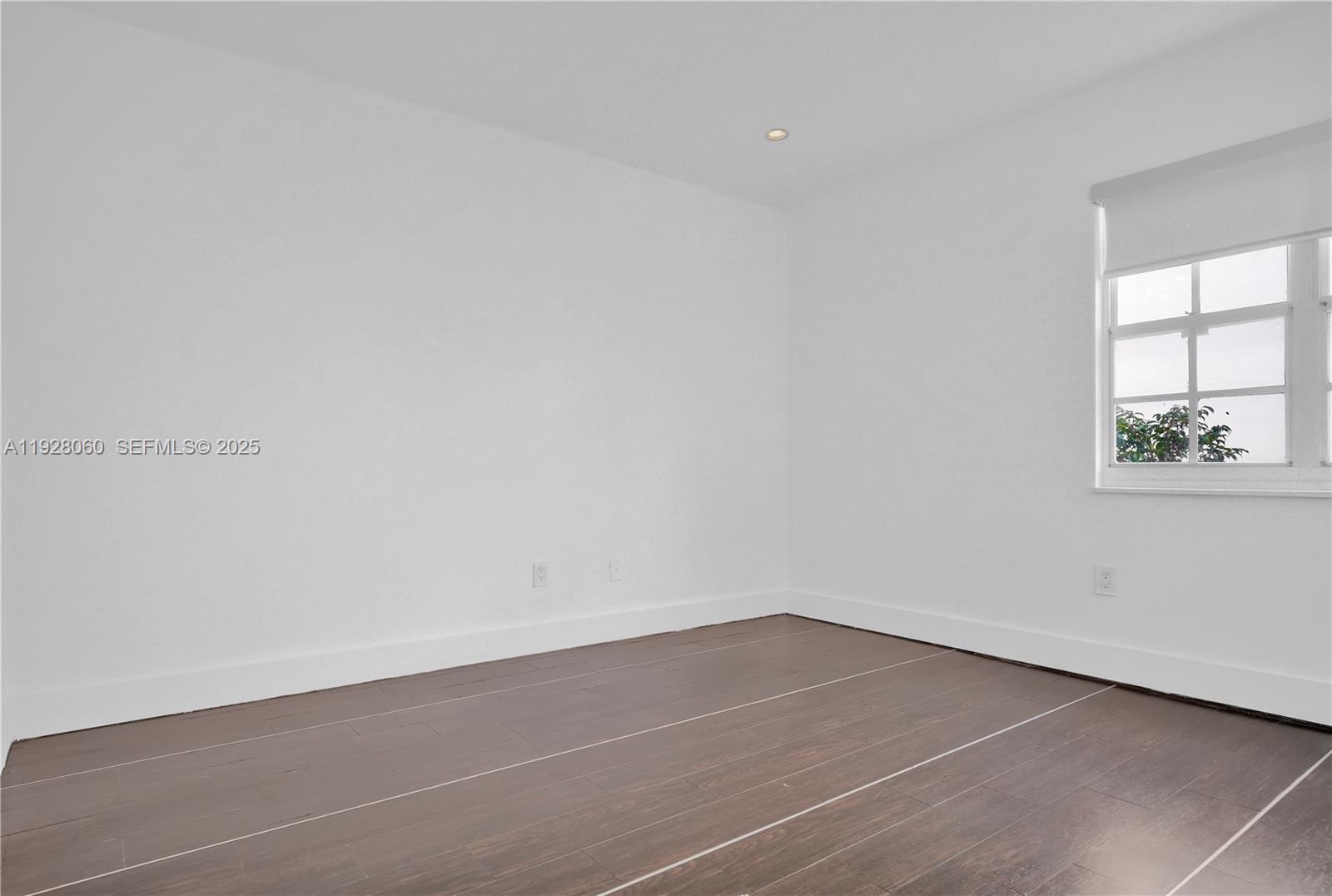 1457 Meridian Avenue, Unit 204 Miami Beach, FL 33139 - Photo 11 of 20 an empty room with a window