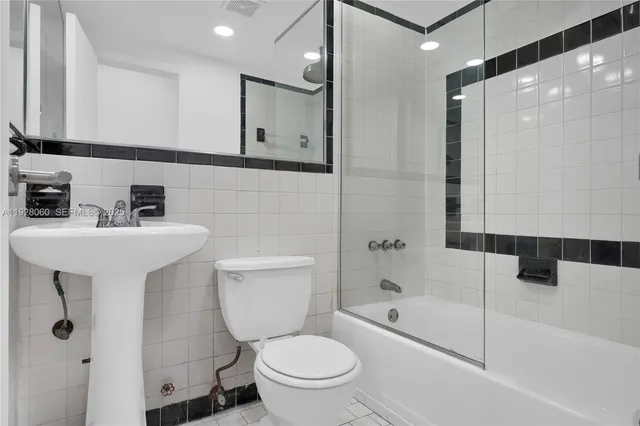 a bathroom with a toilet sink and shower