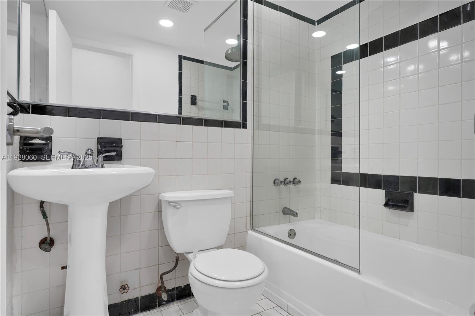 1457 Meridian Avenue, Unit 204 Miami Beach, FL 33139 - Photo 13 of 20 a bathroom with a toilet sink and shower
