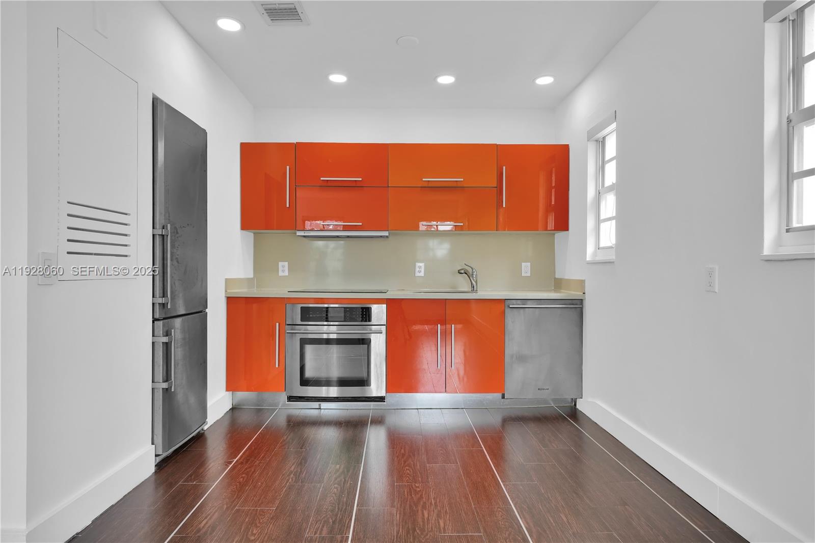 1457 Meridian Avenue, Unit 204 Miami Beach, FL 33139 - Photo 4 of 20 an empty room with a window and wooden floor