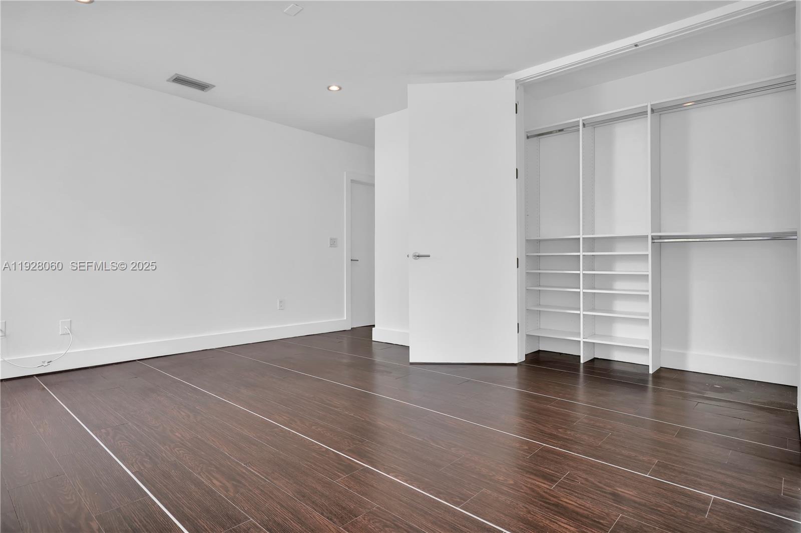1457 Meridian Avenue, Unit 204 Miami Beach, FL 33139 - Photo 8 of 20 wooden floor in an empty room with a window