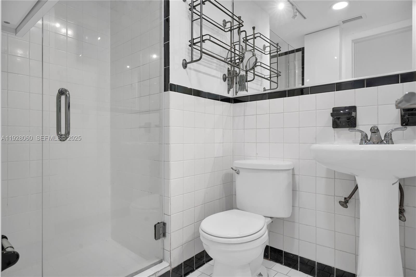 1457 Meridian Avenue, Unit 204 Miami Beach, FL 33139 - Photo 9 of 20 a bathroom with a sink and a toilet