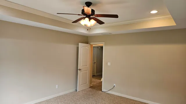 a view of a hallway with a ceiling fan